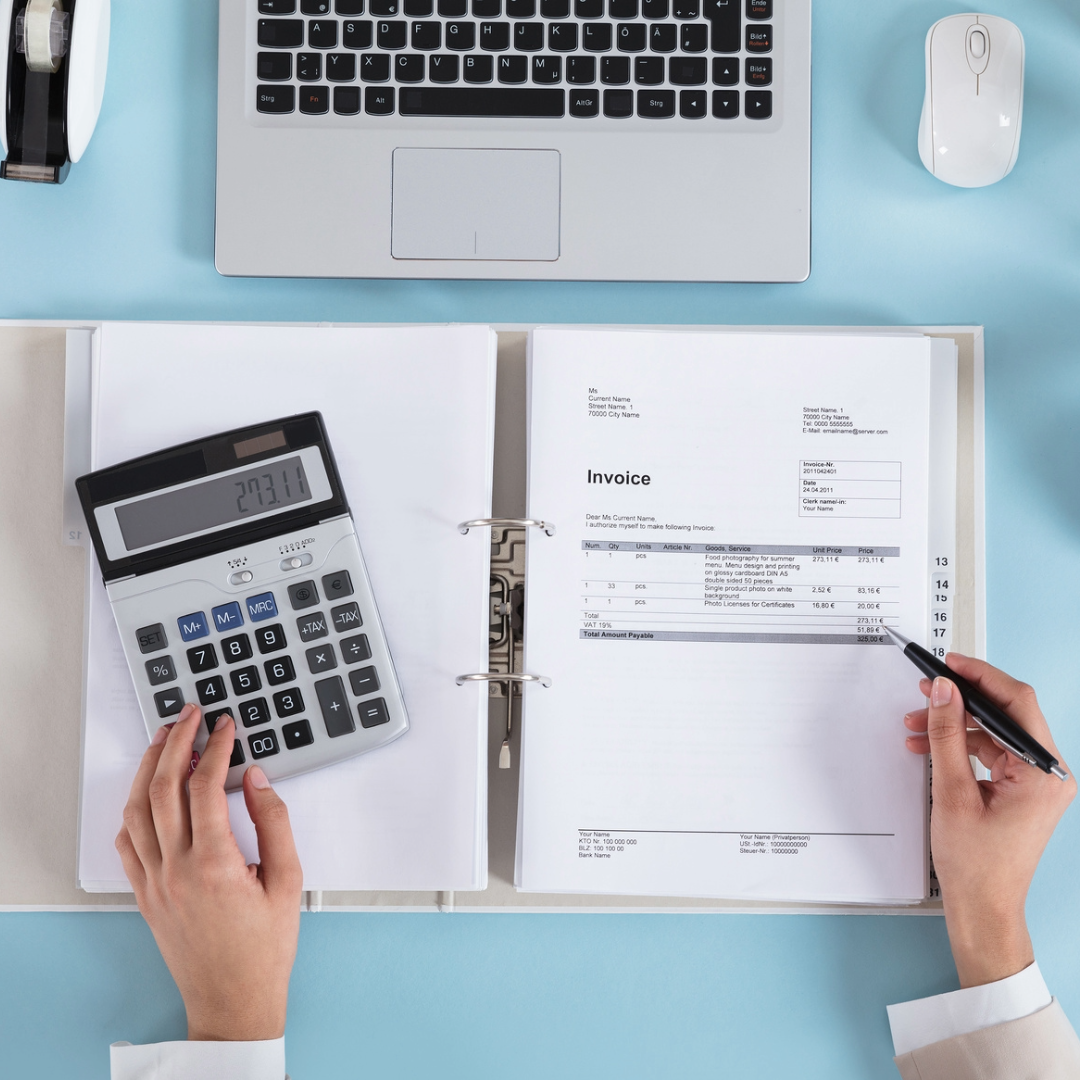 Accounting desk with calculator and binder