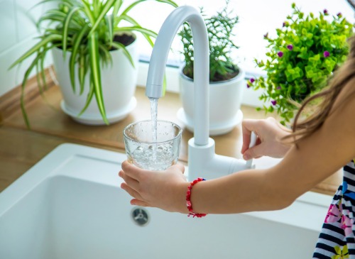 Filling up a glass of water from the tap